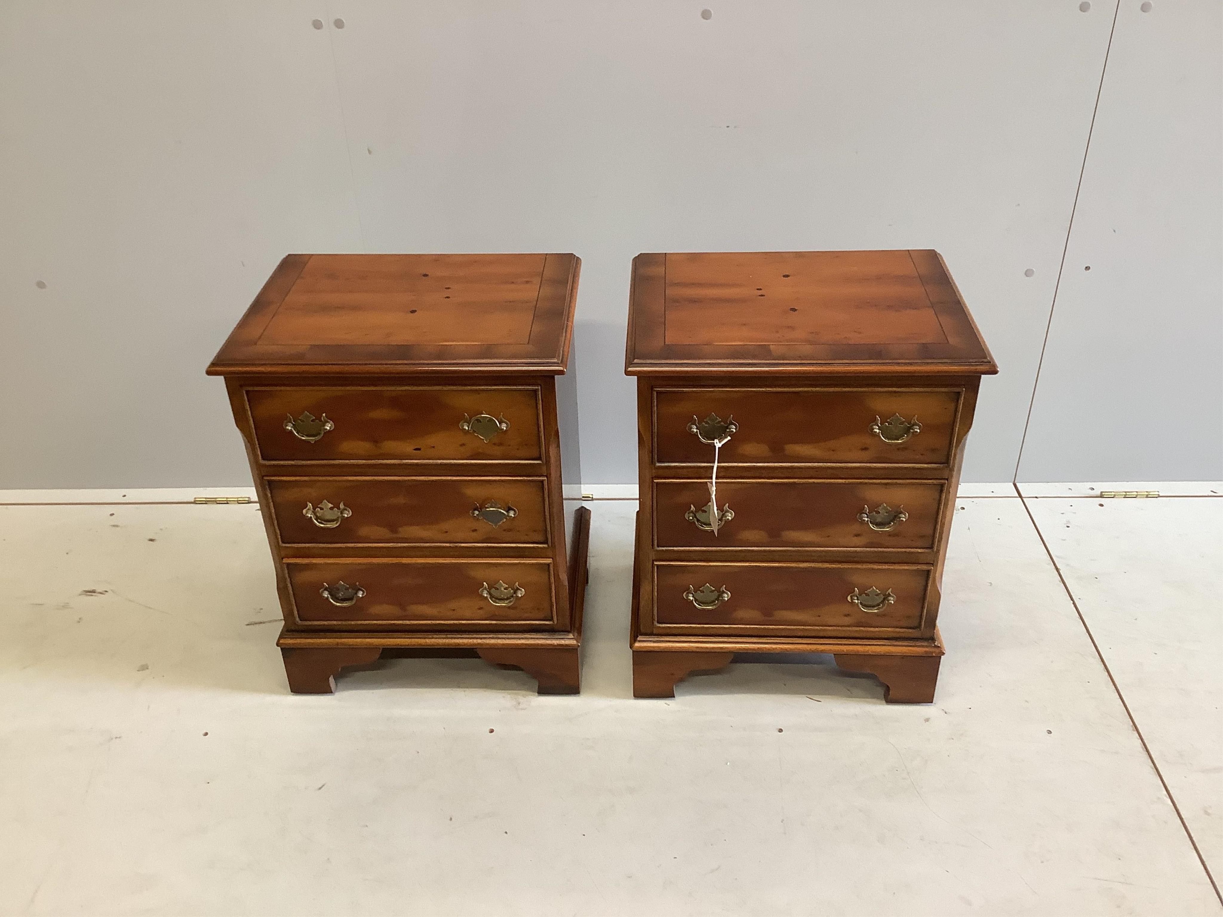 A pair of reproduction yew three drawer bedside chests, width 46cm, depth 35cm, height 60cm. Condition - good